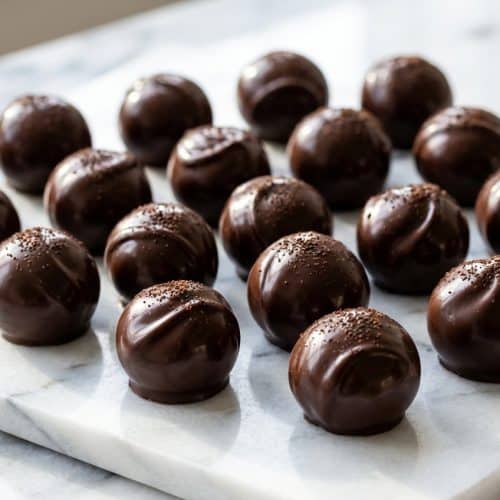 Glossy dark chocolate candy recipes featuring an espresso-infused layer made using the seed tempering technique.