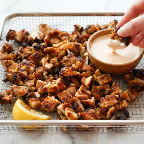 Crispy air fryer chicken thighs dusted with a baking powder dry rub and cooked to a tender 175 degrees.