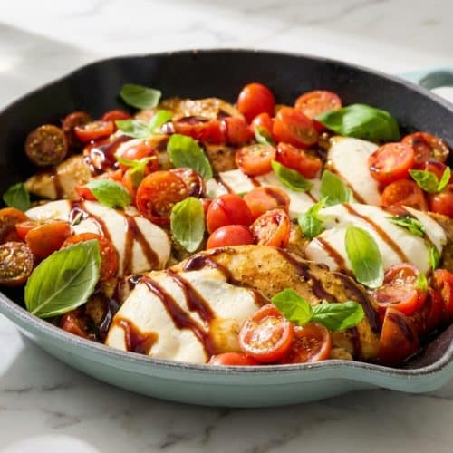 Sizzling chicken caprese topped with creamy burrata cheese, fresh basil, and a savory garlic-rub finish.