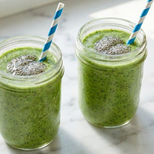 Bright green smoothie recipes for weight loss served in a tall glass featuring soaked chia seeds for added texture.