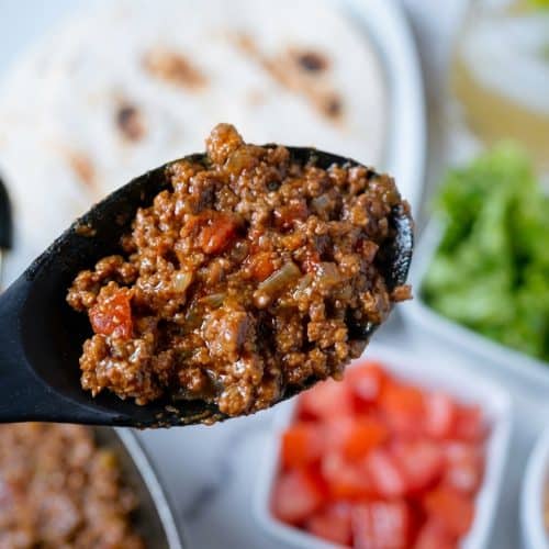 Close-up of saucy Ground Beef Tacos in corn tortillas topped with fresh cilantro, highlighting the rich color from the tomato paste umami boost.
