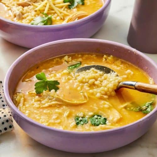 Italian Penicillin Soup with golden ginger and turmeric infused broth topped with tiny pastina stars.