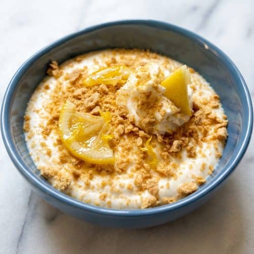 Velvety lemon cheesecake mousse topped with bright zest using the lemon-sugar maceration technique for deep citrus flavor.