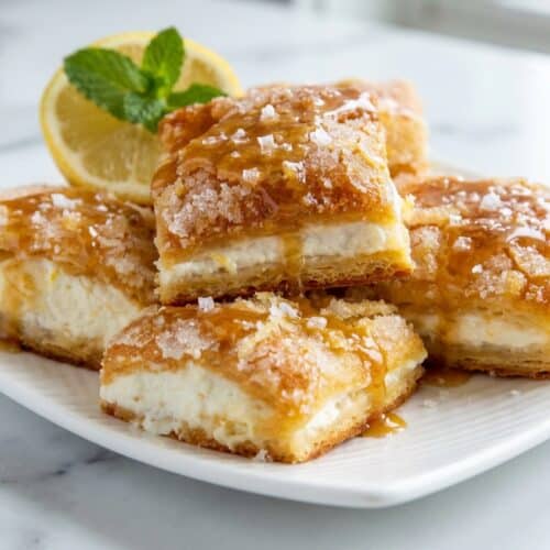 Lemon cream cheese bars topped with a speckled brown butter and sea salt glaze.