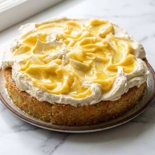 Sliced limoncello mascarpone cake showing the moist crumb achieved from the signature limoncello syrup soak.