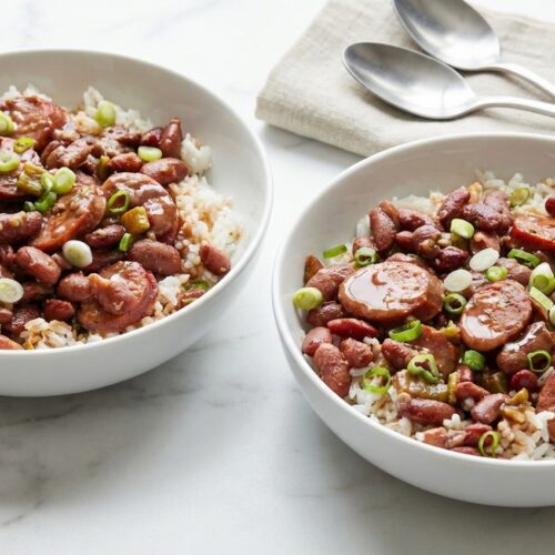 A bowl of Louisiana red beans and rice recipe made creamy with a savory bacon-fat bean emulsion and andouille sausage.