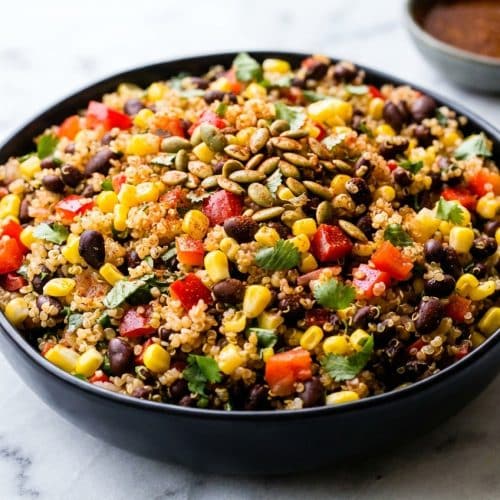 Vibrant mexican quinoa salad topped with smoky paprika dressing and a crunch of toasted pepitas.