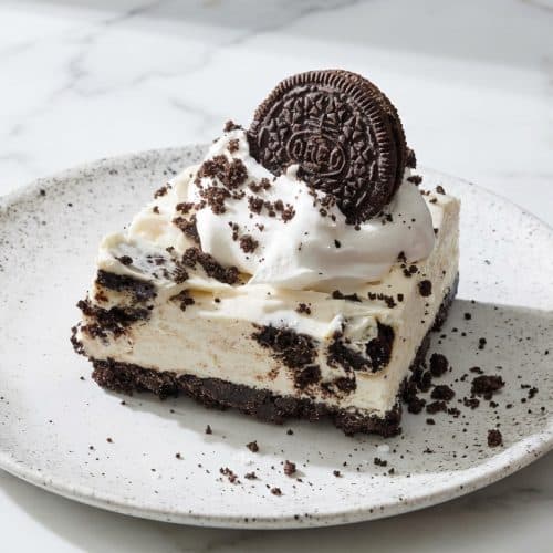 No Bake Oreo Cheesecake with sea salt and an espresso-infused crust on a serving platter.
