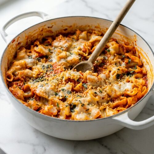 One pot chicken parmesan pasta topped with a crispy toasted panko finish in a Dutch oven.