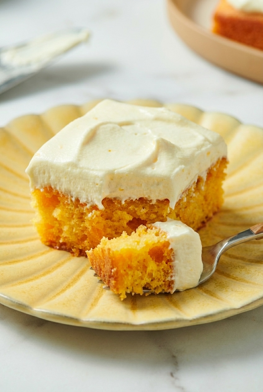 Close-up of the velvety citrus crumb and moist layers of the orange creamsicle cake.