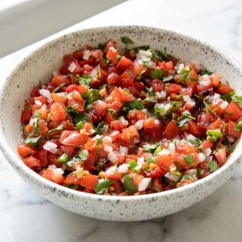 Chunky Pico de Gallo recipe featuring a smoky charred-serrano infusion in a ceramic bowl.