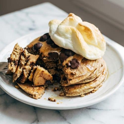 Fluffy protein pancakes stacked high, showcasing the airy lift created by the soufflé-fold technique.