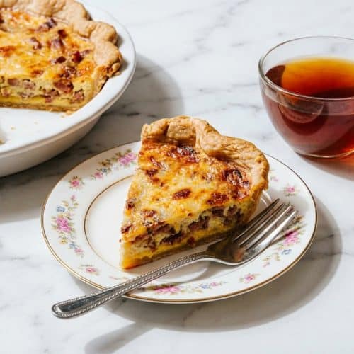 Golden Quiche Lorraine Recipe featuring a savory Dijon mustard layer under creamy custard and smoky lardons.