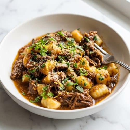 Short Rib Ragu over pappardelle with a glossy Monte au Beurre finish and bright acidity.