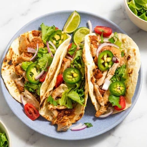 Slow Cooker Chicken Tacos featuring crispy, caramelized shredded chicken edges from a broiler finish.