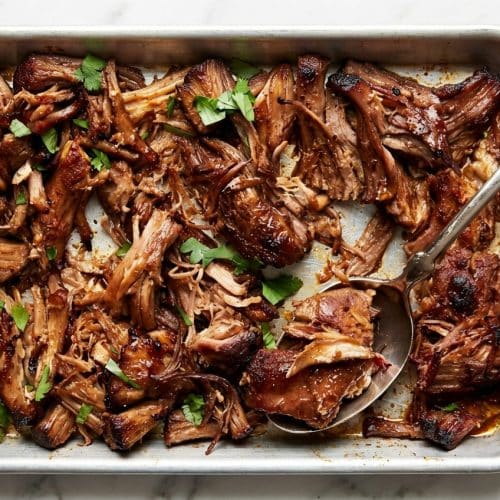 Slow cooker pork carnitas with crispy edges from a caramelized Mexican Coca-Cola and citrus reduction.