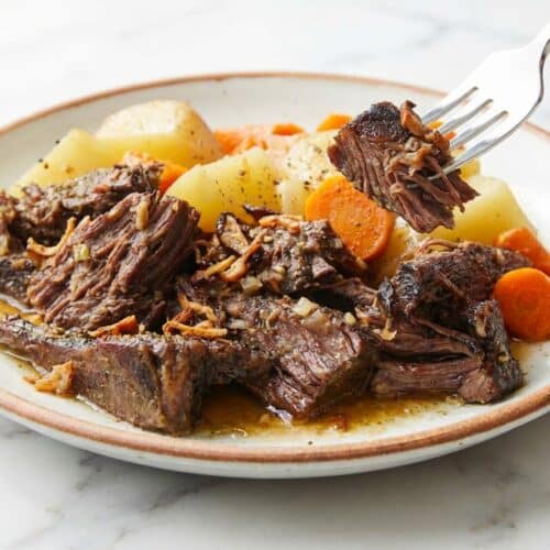 Tender Slow Cooker Pot Roast with a Triple-Umami Sear Technique crust and soft root vegetables.