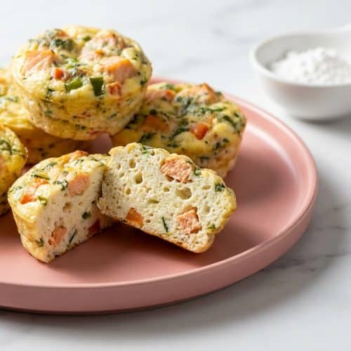 Golden brown cottage cheese egg bites with a perfectly smooth, velvet texture from the cornstarch hack, arranged on a small plate.