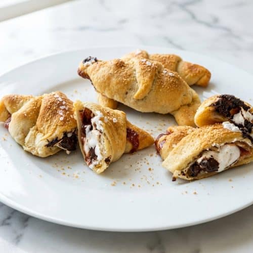 Golden brown S’mores Crescent Rolls finished with a dusting of toasted graham and a pinch of smoked sea salt.