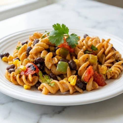 Creamy southwestern pasta salad featuring fire-charred corn, smoky peppers, and rotini in a zesty dressing.