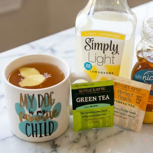 Steaming starbucks medicine ball recipe in a mug infused with fresh ginger slices and a pinch of sea salt.