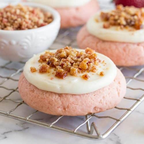 Strawberry crunch cookies topped with nutty brown butter strawberry crunch and creamy frosting.