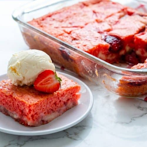 Strawberry Earthquake Cake with balsamic-macerated strawberries and a gooey cream cheese swirl in a baking dish.