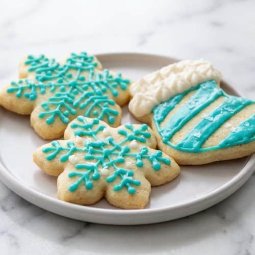Creamy sugar cookie frosting recipe with a rich brown butter and salt infusion swirl on a baked cookie.