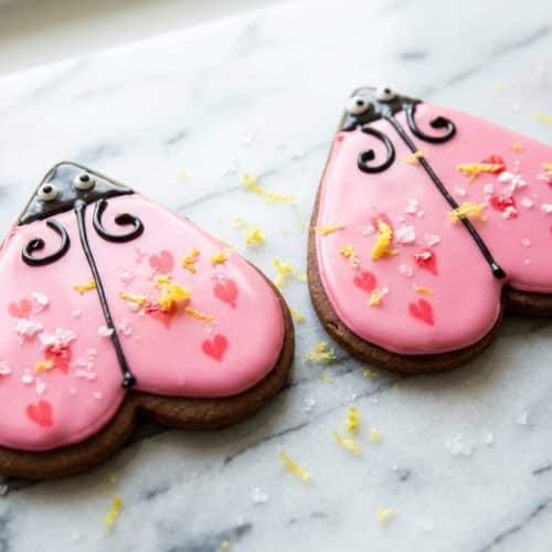 Glossy sugar cookie icing with a hint of lemon and salt on a decorated heart-shaped cookie.