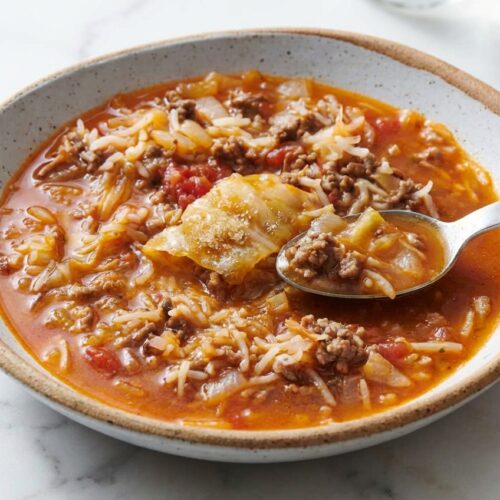 Hearty bowl of cabbage roll soup with a sweet-and-sour sauerkraut and brown sugar broth.