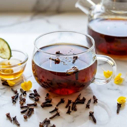 Steaming cup of clove tea recipe made with toasted whole cloves and a tiny pinch of black pepper.