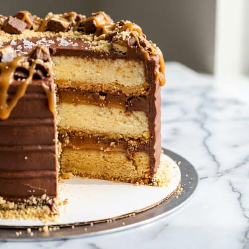 Layered twix cake featuring smoked sea salt and a crispy brown butter shortbread base.