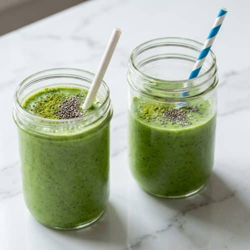 Tall glass of a vibrant Weight Loss Green Smoothie Recipe, blended with chilled green tea and sprinkled with chia seeds.