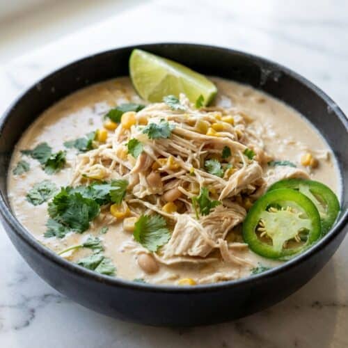 Creamy white chicken chili slow cooker bowl made savory with a Parmesan rind and white miso infusion.