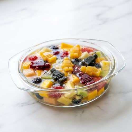 Clear agar agar fruit jelly recipe featuring fresh, colorful fruit chunks suspended in a pandan-infused coconut water base.