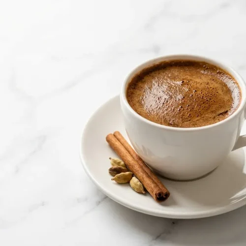 Steaming cup of our yemeni coffee recipe, brewed thick and rich using toasted spices and a triple boil and rest method.