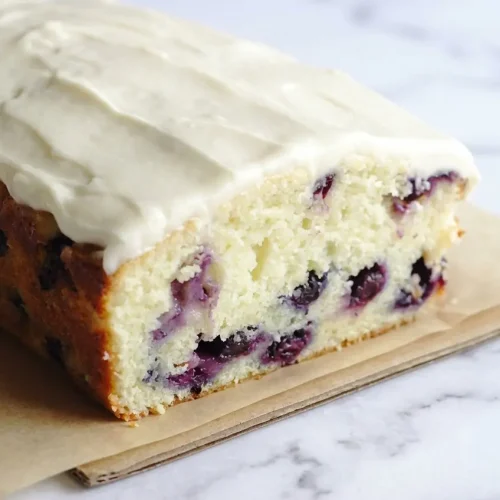 Blueberry Lime Loaf with Cream Cheese Frosting featuring zesty lime-infused sugar and a thick, citrus glaze.