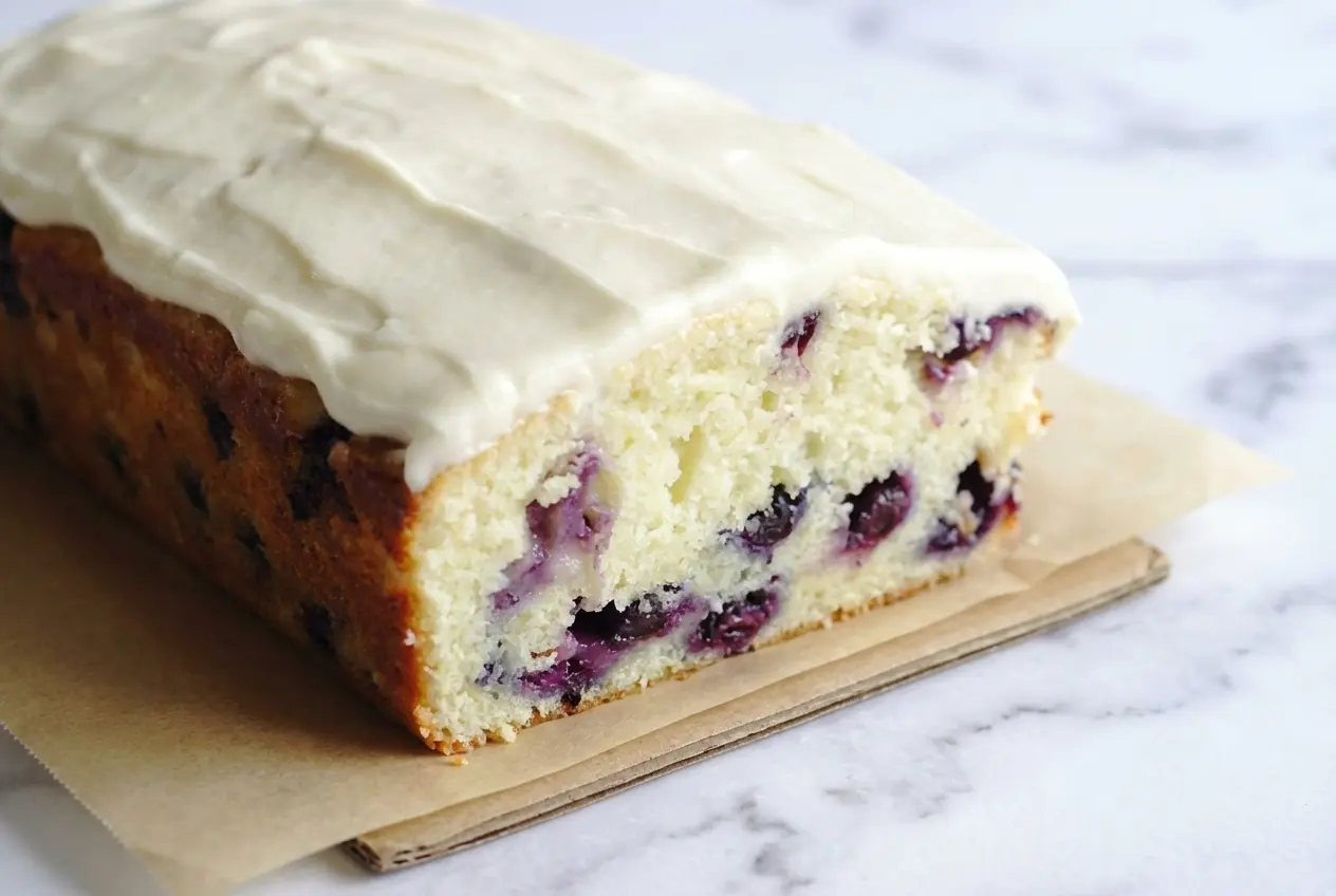 Blueberry Lime Loaf with Cream Cheese Frosting featuring zesty lime-infused sugar and a thick, citrus glaze.