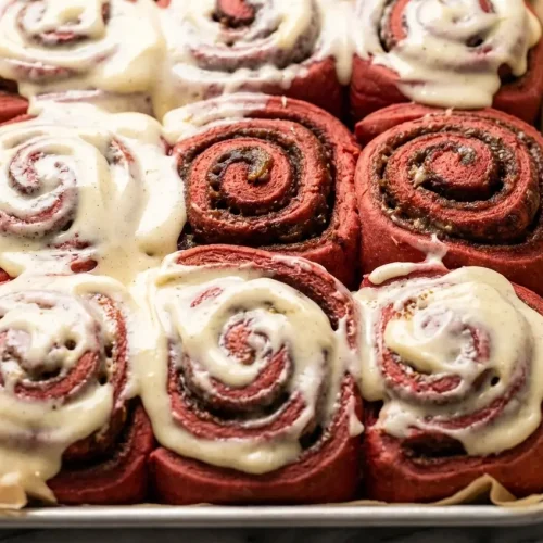 Red Velvet Cinnamon Rolls with a tangy buttermilk and brown butter infusion and thick cream cheese frosting.
