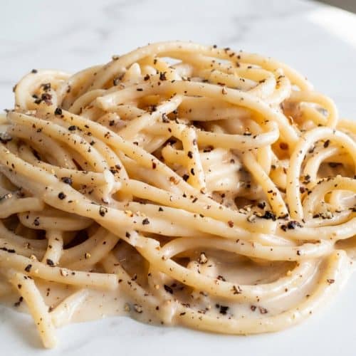 Creamy bucatini cacio e pepe featuring a silky sauce achieved through the hybrid tempering method.