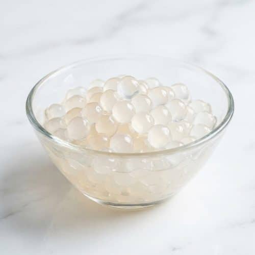 Clear and glassy crystal boba recipe pearls with a chewy vegan konjac-agar texture served in a glass bowl.