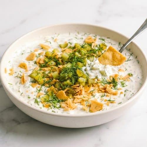 Creamy Dill Pickle Dip garnished with fresh dill, featuring the flavor-enhancing Brine-Bloom seasoning technique.