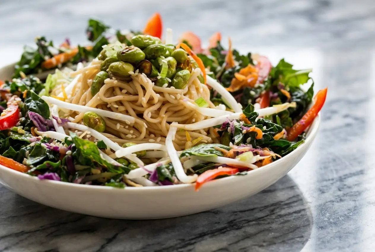 Colorful edamame rice noodle salad featuring charred blistered edamame and savory smacked cucumbers in a large bowl.