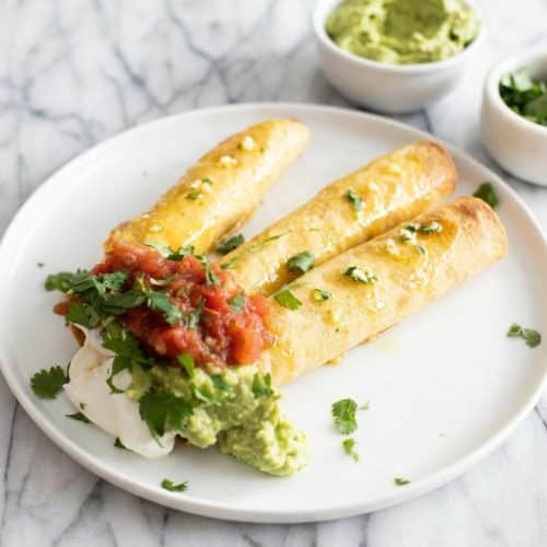 Golden Egg and Sausage Breakfast Taquitos brushed with garlic-cilantro oil for a crispy air-fried finish.