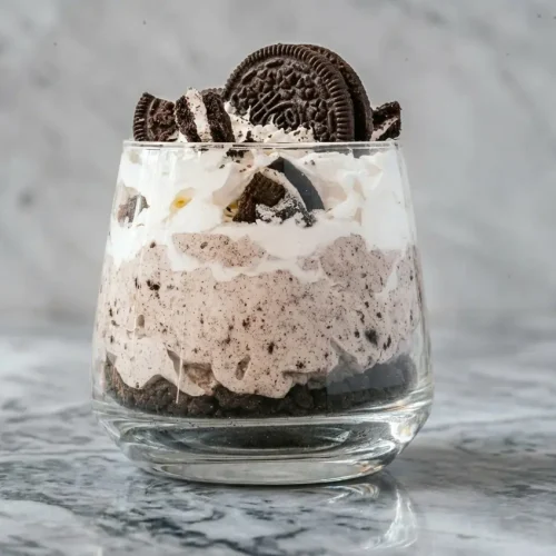 Cookies and Cream Mousse Cups in glass jars with espresso-infused cream and a pinch of sea salt.