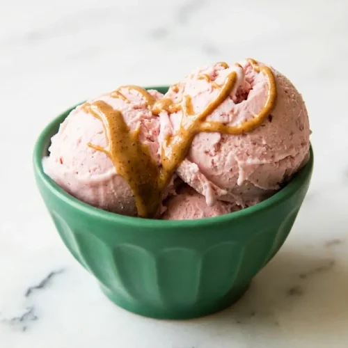Scoop of High Protein Cottage Cheese Ice Cream in a bowl showing a creamy texture from cashew butter and xanthan gum.