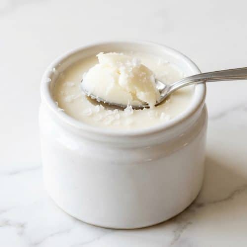 Pure white rendered fat in mason jars showing how to make beef tallow using the osmotic purge and double render method.