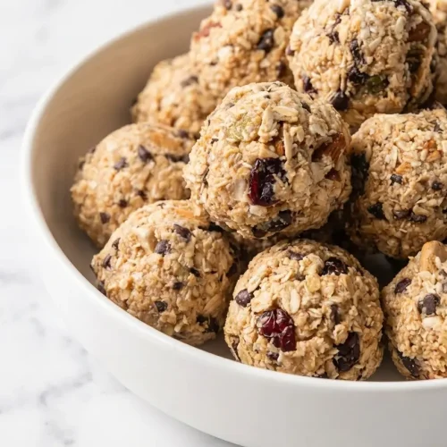 A stack of energy bites from a kodiak protein balls recipe made with milk and finished with flaky sea salt.