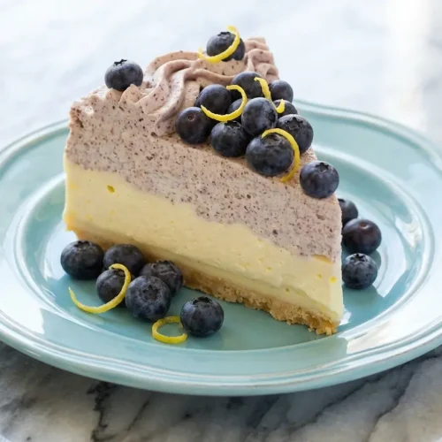 Lemon Blueberry Shortbread Mousse Cake featuring a nutty brown butter shortbread crust and vibrant layers.