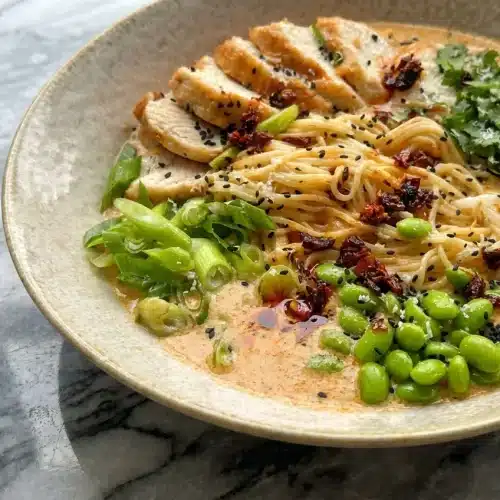 Creamy Marry Me Chicken Ramen with sun-dried tomatoes, savory miso paste, and a bright squeeze of fresh lime.